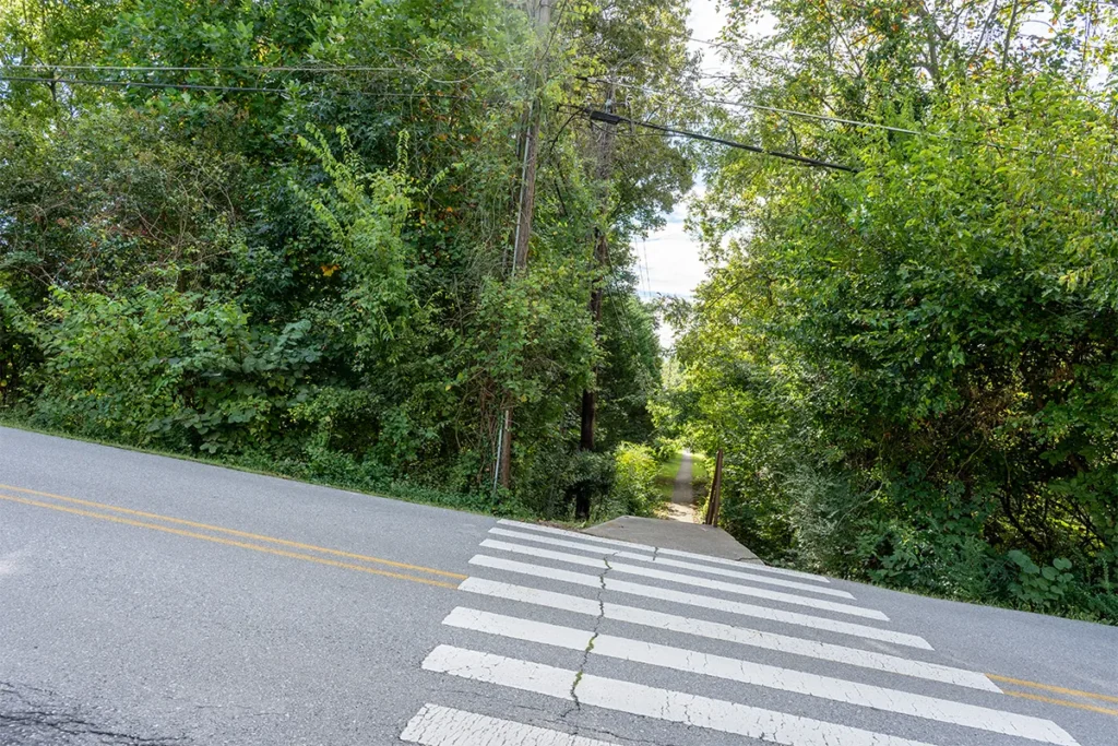 White-striped crosswalk across Sonja Drive leading to the Farragut school-campus connector entrance